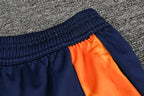 Traje de entrenamiento naranja y azul del Real Madrid 2025-26