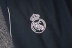 Chándal de entrenamiento gris oscuro (texto rosa claro) con cremallera larga del Real Madrid 2025-26